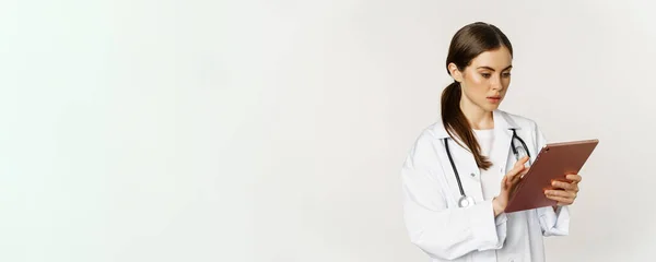 Woman Doctor Looking Concerned Digital Tablet Reading Worried Face Expression — Foto de Stock