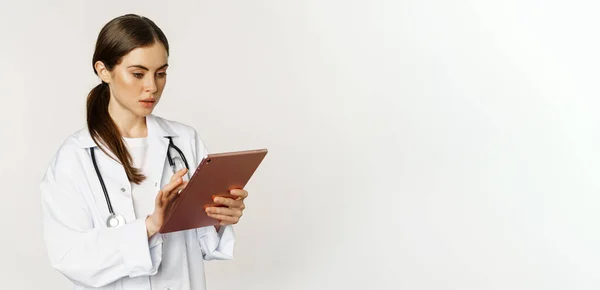 Woman Doctor Looking Concerned Digital Tablet Reading Worried Face Expression — Foto de Stock