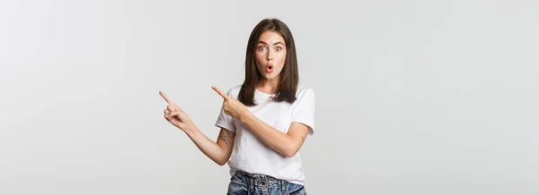 Impressed Amused Brunette Girl Say Wow Pointing Upper Right Corner — Stock Photo, Image