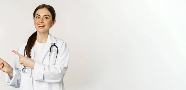 Portrait Smiling Young Woman Doctor Healthcare Medical Worker Pointing Fingers — Stok fotoğraf