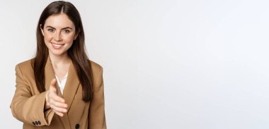 Portrait of smiling businesswoman extend hand for handshake, greeting business partner, saleswoman welcome client, white background.