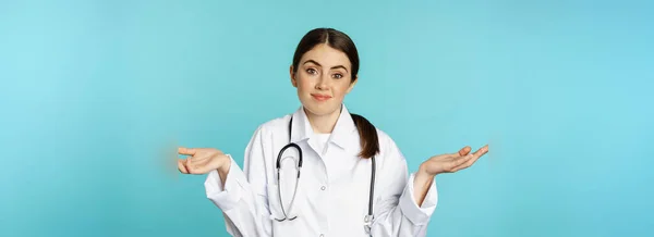 Portrait Doctor Woman Intern Shrugging Shoulders Smiling Saying Sorry Dont — Stock Fotó