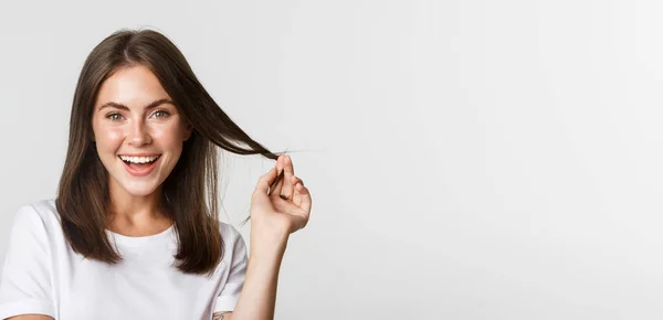 stock image Portrait of flirty beautiful girl playing with hair and smiling at camera intrigued.