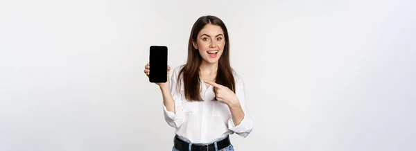 Happy Beautiful Woman Smiling Pointing Mobile Phone Screen Showing Advertisement — Foto de Stock
