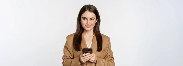 Smiling Businesswoman Using Smartphone App Mobile Phone Standing White Background — Stockfoto