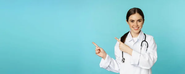 Portrait Smiling Medical Worker Girl Doctor White Coat Stethoscope Pointing — Foto de Stock