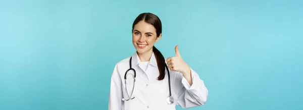 Smiling Girl Doctor Healthcare Worker Stethoscope Showing Thumb Approval Recommending — Zdjęcie stockowe