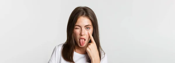 Close Silly Attractive Young Girl Showing Tongue Pulling Eyelid Watching — Stock Photo, Image