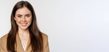 Real professional. Smiling businesswoman looking confident, determined face expression, standing in suit over white background.