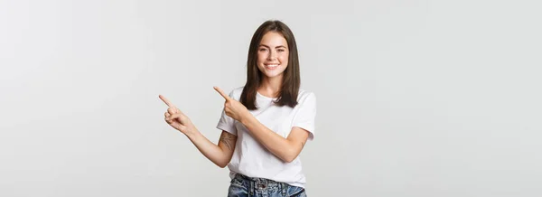 Attractive Smiling Brunette Girl Pointing Fingers Upper Right Corner Showing — Stock Photo, Image