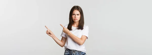 Disappointed Sulking Girl Pointing Fingers Upper Right Corner Frowning Complaining — Stock Photo, Image