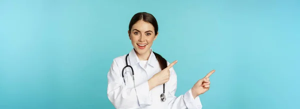 Portrait Smiling Medical Worker Girl Doctor White Coat Stethoscope Pointing — стоковое фото