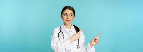 Portrait Smiling Medical Worker Girl Doctor White Coat Stethoscope Pointing — Fotografia de Stock