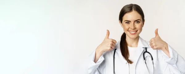 Portrait Smiling Beautiful Woman Doctor White Coat Showing Thumbs Standing — Stok fotoğraf