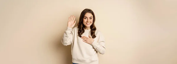 Cute Modest Girl Smiling Raising Finger Introduce Herself Saying Hello — Zdjęcie stockowe