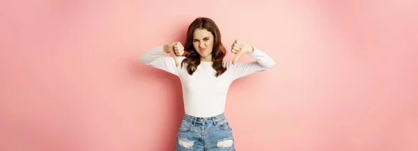 Portrait Young Woman Showing Thumbs Express Dislike Disappointed Standing Pink — Stockfoto
