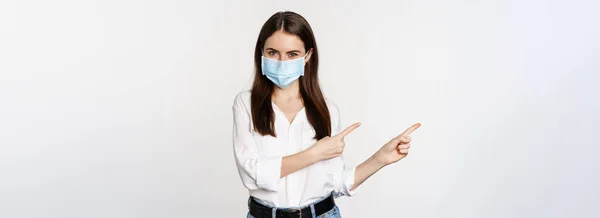 Portrait Corporate Woman Face Medical Mask Pointing Fingers Left Showing —  Fotos de Stock