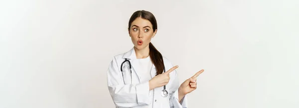 Surprised Doctor Physician Pointing Fingers Left Looking Logo Banner Showing — Zdjęcie stockowe