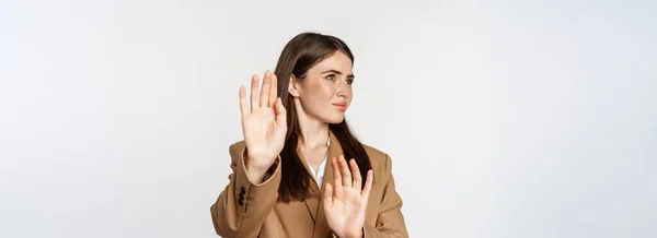 stock image Embarrassed woman turn away from something disgusting, refusing, rejecting, standing displeased against white background.