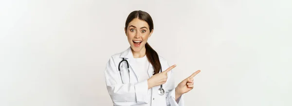 Portrait Smiling Young Woman Doctor Healthcare Medical Worker Pointing Fingers — Zdjęcie stockowe