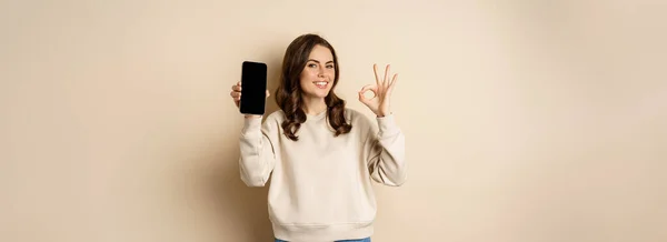 Smiling Happy Girl Showing Smartphone Screen App Mobile Interface Okay — Stok Foto