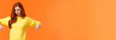 Kıskanç, üzgün ve somurtkan, sarı kazaklı, kıskançlık ve hayal kırıklığıyla bakan, kıskanç ve üzgün bir kadın..