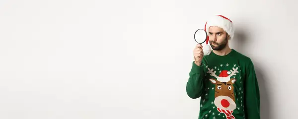 Christmas Holidays Concept Young Man Santa Hat Searching Something Magnifying — Stock Photo, Image