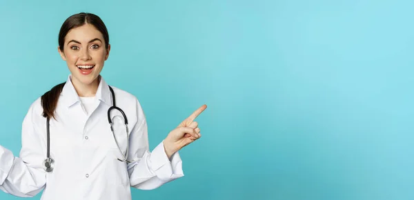 Enthusiastic Woman Doctor Medical Worker White Coat Pointing Fingers Sidweays — Foto de Stock
