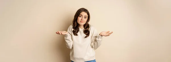 Clueless Cute Girl Shrugging Smiling Standing Beige Background — Photo
