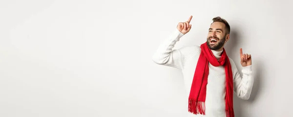 stock image Happy man celebrating new year party, dancing and pointing fingers, standing over white background.