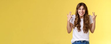 Pissed fed up angry freaked-out woman gesturing intense shaking hands furiously being outraged clench teeth frowning grimacing disappointed complain swearing cursing rude yellow background.