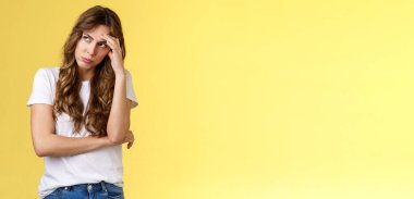 Gosh what nuisance. Embarrassed annoyed young ignorant displeased woman exhale air breathing out gasping irritated look away hiding face feel humiliated pissed attend uninteresting event.