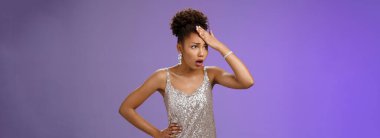 Annoyed arrogant african-american wealthy woman in silver shiny dress irritated bothered stupid servants punch forehead pissed fed up gasping fed up look aside, hear ridiculous story, blue background.