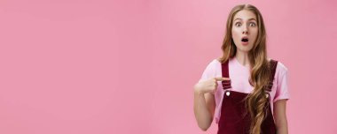 Belirsiz ve kafası karışmış, dövmeleri olan, uzun doğal dalgalı saçları olan, nefes nefese kalan, şaşırmış ve şaşırmış gözleri olan genç bir kadın. Vücut