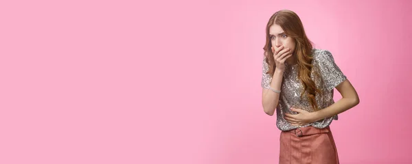 Portrait intense girl feel bad after party alcohol intoxication touching stomach cover mouth widen eyes suffering stomach disorder, puke, vomit, suffering belly discomfort pink background.