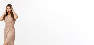 Noel partisi ve kutlama konsepti. Uzun boylu, esmer bir kadın. Şaşırmış görünüyor. Şık giyinmiş ve kameraya bakıyor..