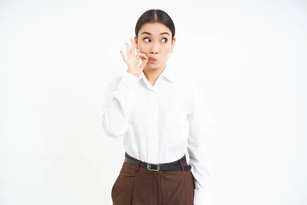 stock image Woman zips her lips, makes seal gesture on mouth, keeps secret, gossips in office, white background.