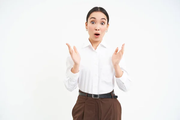 stock image Impressed young female manager, claps hands with amazed face expression, white background.