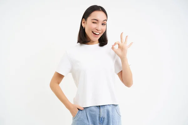 stock image Portrait of confident woman, showing okay, ok sign in approval, nod and say yes, recommend smth, standing over white background.