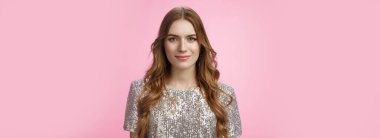 Kendine güvenen, çekici, şık bir kadın akşam makyajı, kıvırcık saç stili parti kıyafeti, kendine güvenen, kendine güvenen bir gece kulübü, mutlu bir pembe arka plan..