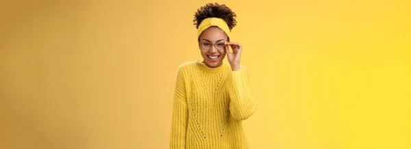 stock image Cute clever best student college girl african-american touch glasses nose smiling broadly work part-time tutor children english lessons smiling friendly standing yellow background sweater, headband.