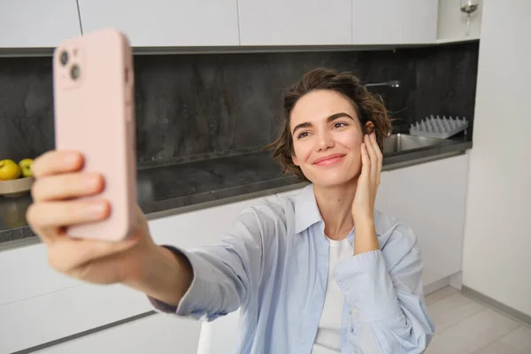 stock image Image of stylish young woman blogger, recording video of herself, taking pictures on smartphone, making selfie at home.