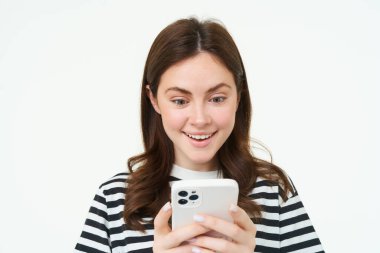 Cep telefonu ekranına şaşırmış bir kadının portresi çevrimiçi dükkanda beyaz arka planda duran inanılmaz bir tanıtım okuyor..