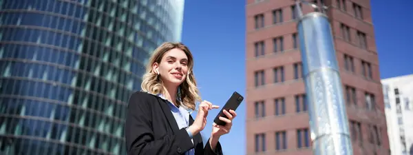 Low Angle Shot Businesswoman Standing Street Sunny Day Holding Smartphone Royalty Free Stock Photos