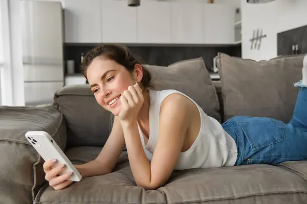 Portrait Cute Young Woman Smartphone Lying Couch Resting Home Scrolling — Stock Photo, Image