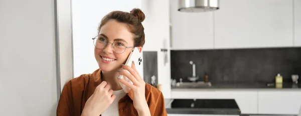 stock image Portrait of happy smiling young woman at home, talking on mobile phone, calling friend and having nice conversation, answer telephone.