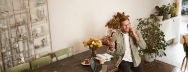 Mutlu genç müdürün portresi, pazarlık yapan adam, telefonla konuşan, cep telefonuyla konuşan, masada dizüstü bilgisayarla oturan..