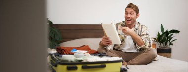 Karizmatik, yakışıklı bir adamın portresi. Deftere bakan bir turist. Yolculuğa hazırlanıyor..