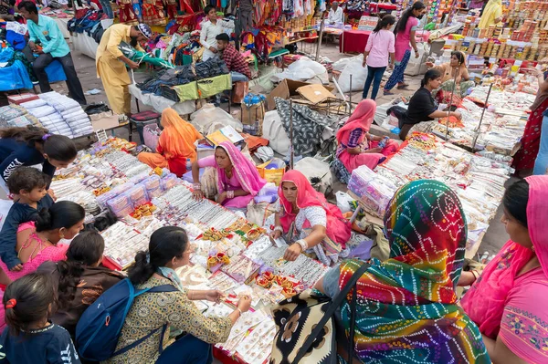 stock image Jodhpur, Rajasthan, India - 20.10.2019 : White necklaces, gold plated earrings and ornaments are being sold to young female customers at famous Sardar Market and Ghanta ghar Clock tower in Jodhpur.