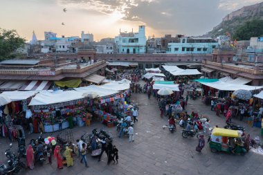 Jodhpur, Rajasthan, Hindistan - 16.10.2019: Arkaplanda Mehrangarh kalesi bulunan ünlü Sardar Pazarı ve Ghanta ghar saat kulesi.